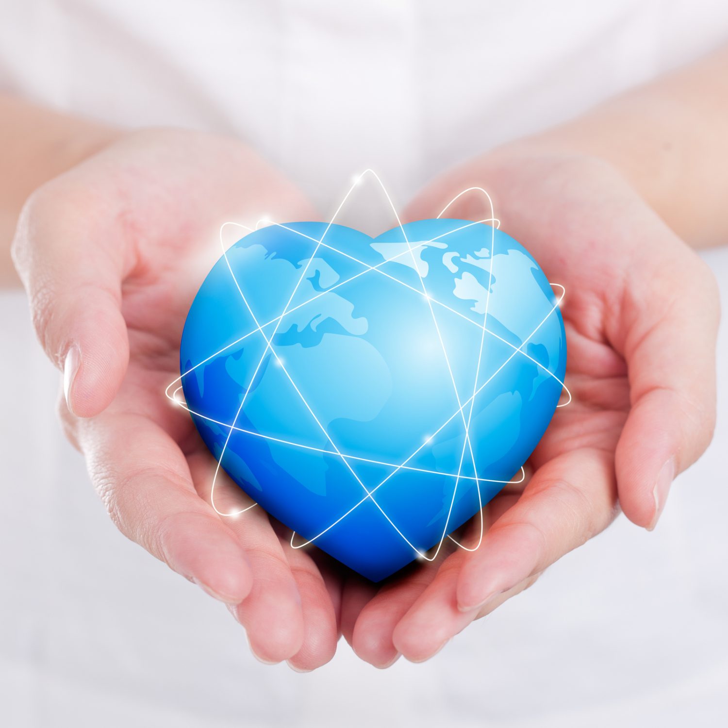 Female hands holding on earth global heart.